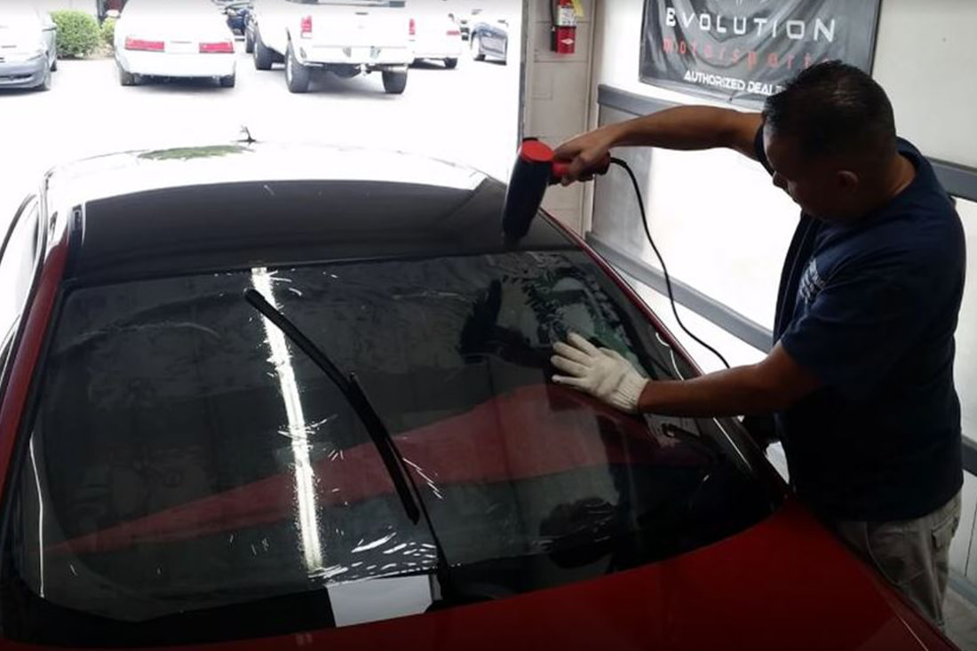 Man tinting a windshield